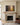 Trust in the Lord painting-style canvas centered above a limestone fireplace and white oak mantel in a panelled family room