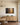 Painting-style canvas of sunbeams through tall trees with the Trust in the Lord verse above an oak sideboard in a dining room