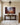 Cross shadow nativity canvas in an entry hall above a dark oak console with a bowl of clementines