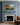 Painted meadow and stream canvas with He restoreth my soul lettering centered above a blue-grey paneled fireplace mantel