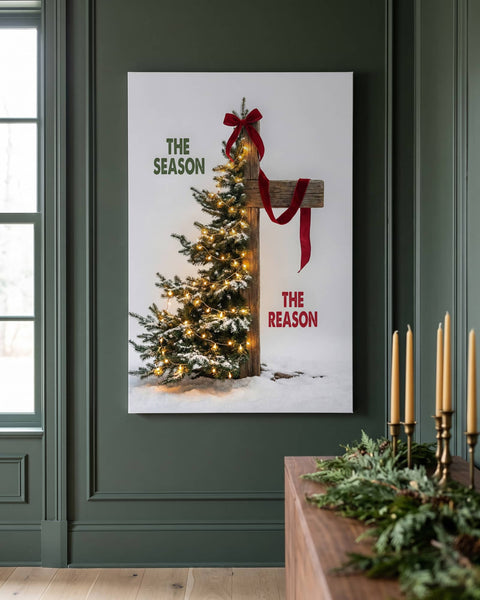 Front view of the Christmas tree and wooden cross canvas hanging on a deep green panelled wall above a console with cedar garland and brass candlesticks
