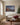 Bethlehem cave and shepherds Christmas canvas above an oatmeal linen sofa beside a Fraser fir with clear glass ornaments