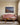 Shepherds walking toward the firelit nativity cave, canvas above a rose linen camelback settee in a cream panelled room