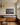 Night sky with a cross-shaped star over Bethlehem, canvas above an oak sideboard dressed with cedar in a Tudor dining room
