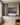 Holy Family and shepherds Christmas canvas print on the center panel between built-in bookcases in a home library