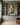 Portrait Christian canvas between built-in bookshelves in an olive-grey home study