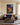 Jesus and the lost lamb canvas wall art hanging above a navy wool sofa in a bright living room
